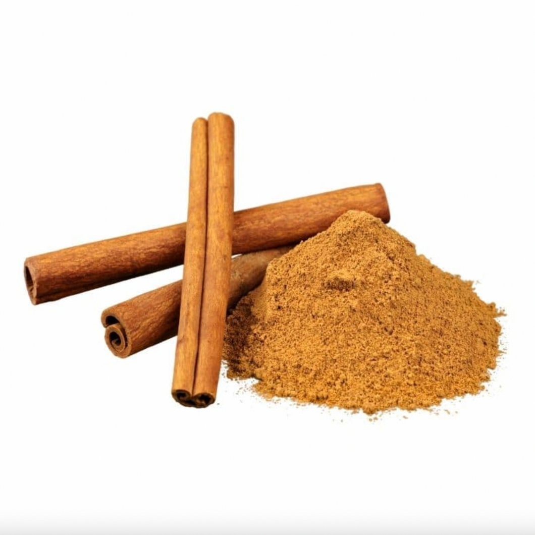 Pile of Cinnamon powder with three cinnamon quills on white background